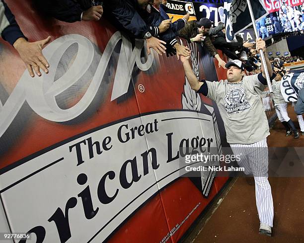Joba Chamberlain of the New York Yankees celebrates with fans after their 7-3 win against the Philadelphia Phillies in Game Six of the 2009 MLB World...