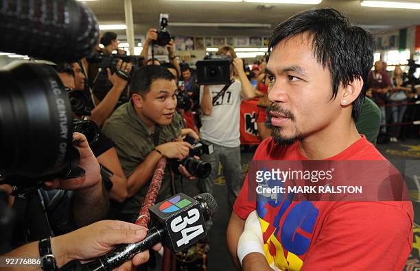 Welterweight boxing champion Manny "PacMan" Pacquiao of the Philippines, talks to the press as he prepares for his fight against Miguel Cotto, at the...