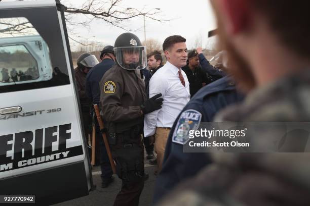 White nationalist Greg Conte is taken into custody after alt-right advocates clashed with counter-demonstrators before the start of a speech by white...