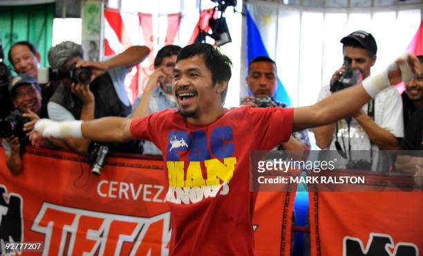 Welterweight boxing champion Manny "PacMan" Pacquiao of the Philippines, laughs as he prepares for his fight against Miguel Cotto, at the Wild Card...