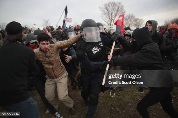 Police clash with demonstrators as they escort people into a speech by white nationalist Richard Spencer, who popularized the term 'alt-right', at...