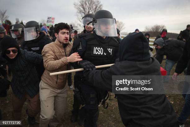 Police clash with demonstrators as they escort people into a speech by white nationalist Richard Spencer, who popularized the term 'alt-right', at...