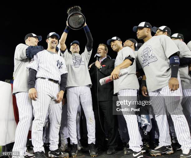 Burnett, Jorge Posada, Derek Jeter, Mariano Rivera and Robinson Cano of the New York Yankees celebrate with the trophy after their 7-3 win against...
