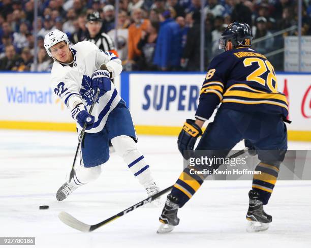 Nikita Zaitsev of the Toronto Maple Leafs takes a shot as Zemgus Girgensons of the Buffalo Sabres defedns during the first period at KeyBank Center...