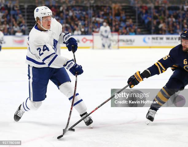 Kasperi Kapanen of the Toronto Maple Leafs takes a shot as Marco Scandella of the Buffalo Sabres defends during the first period at KeyBank Center on...