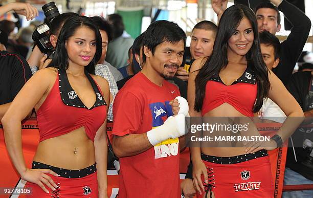 Welterweight boxing champion Manny "PacMan" Pacquiao of the Philippines, poses for photos as he prepares for his fight against Miguel Cotto, at the...