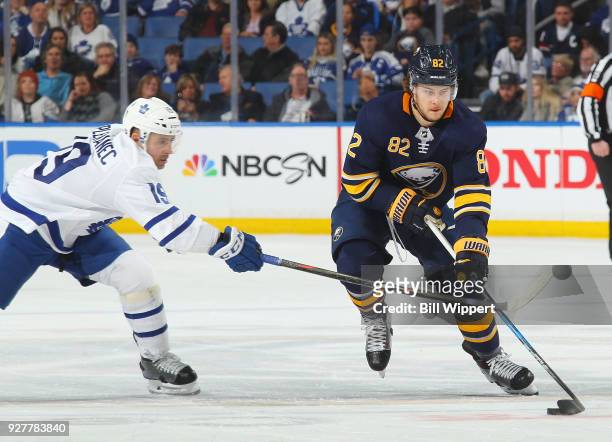 Nathan Beaulieu of the Buffalo Sabres controls the puck against Tomas Plekanec of the Toronto Maple Leafs during an NHL game on March 5, 2018 at...
