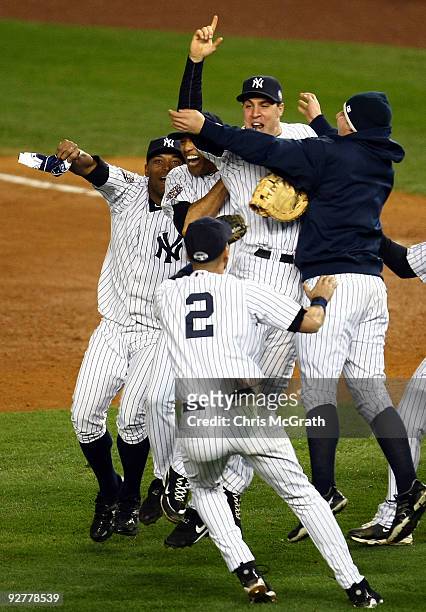 Mark Teixeira of the New York Yankees celebrates with teammates on the field after their 7-3 win against the Philadelphia Phillies in Game Six of the...