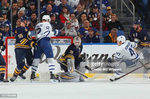 Leo Komarov of the Toronto Maple Leafs scores a first period goal against Chad Johnson of the Buffalo Sabres during an NHL game on March 5, 2018 at...