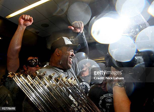 Sabathia of the New York Yankees celebrates with the trophy in the locker room after their 7-3 win against the Philadelphia Phillies in Game Six of...