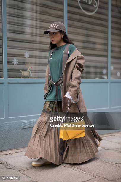 Christine Paik is seen on the street attending Sacai during Paris Women's Fashion Week A/W 2018 wearing Sacai with yellow bag on March 5, 2018 in...