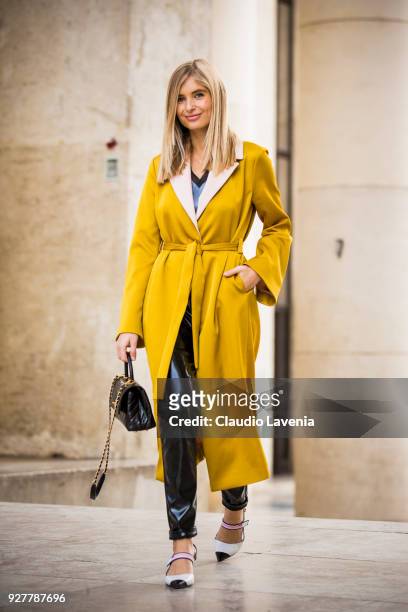 Xenia van der Woodsen, wearing a yellow Stine Goya trench, a Prada shoes and a Chanel bag, is seen in the streets of Paris after the Giambattista...