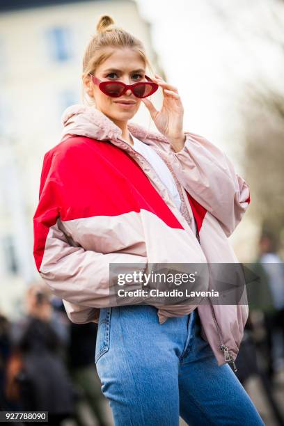 Lena Perminova, wearing Giambattista Valli down jacket and white heels boots, is seen in the streets of Paris after the Giambattista Valli show...