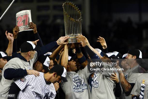 The New York Yankees celebrate with the trophy after their 7-3 win against the Philadelphia Phillies in Game Six of the 2009 MLB World Series at...