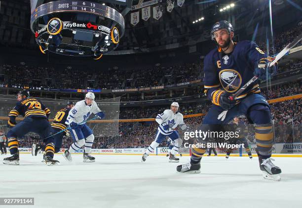 Marco Scandella of the Buffalo Sabres looks to make a play along the boards during an NHL game against the Toronto Maple Leafs on March 5, 2018 at...