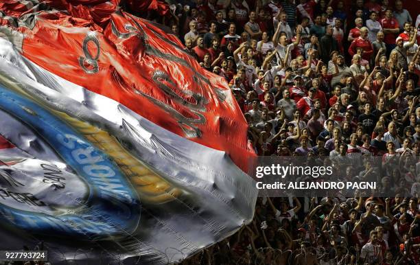 Supporters of Argentinos Juniors cheer for their team during their Argentina First Division Superliga football match against Boca Juniors at Diego...