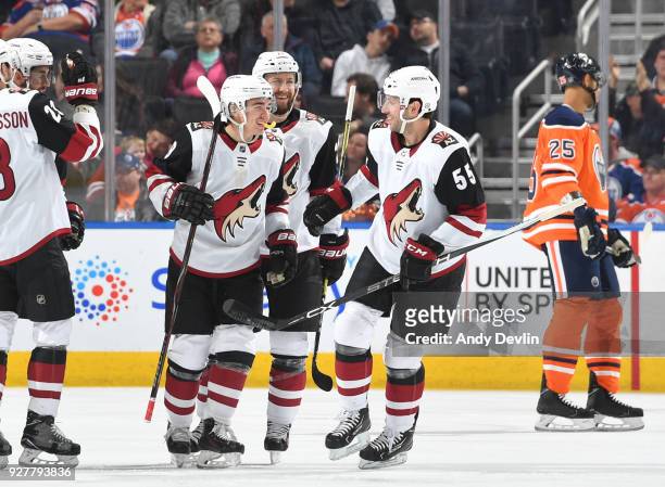 Clayton Keller, Jason Demers and Derek Stepan of the Arizona Coyotes celebrate after a goal during the game against the Edmonton Oilers on March 5,...