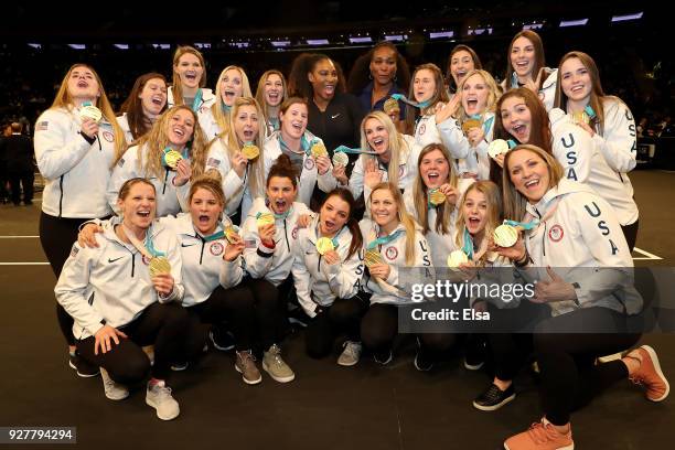 The United States Women's Olympic hockey team poses with their gold medals and tennis champions Serena Williams anf Venus Williams during the Tie...