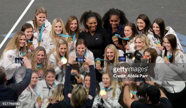 Serena Williams and Venus Williams pose with the Team USA Women's Hockey Team during the Tie Break Tens at Madison Square Garden on March 5, 2018 in...