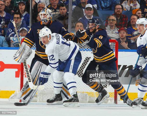 Chad Johnson and Marco Scandella of the Buffalo Sabres defend against Patrick Marleau of the Toronto Maple Leafs during an NHL game on March 5, 2018...