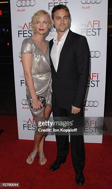 Actress Charlize Theron and actor Stuart Townsend arrive at AFI Fest 2009 - "The Road" Los Angeles Premiere at Grauman's Chinese Theatre on November...