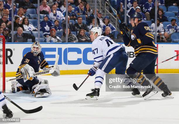 Chad Johnson and Rasmus Ristolainen of the Buffalo Sabres defend against Leo Komarov of the Toronto Maple Leafs during an NHL game on March 5, 2018...