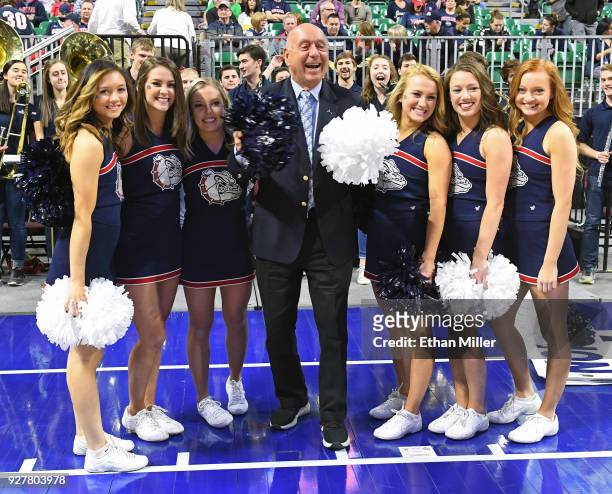 Sportscaster Dick Vitale poses with Gonzaga Bulldogs cheerleaders before the team's semifinal game of the West Coast Conference basketball tournament...