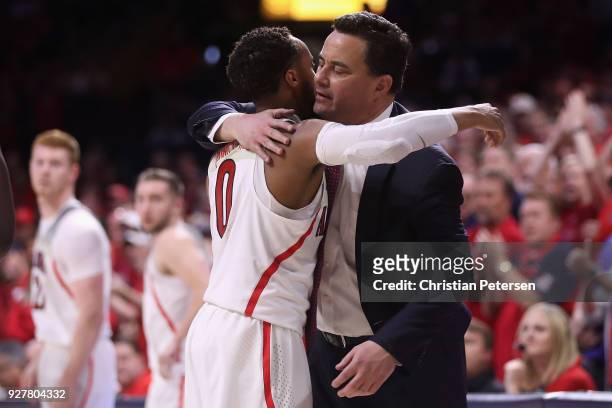 Head coach Sean Miller of the Arizona Wildcats hugs Parker Jackson-Cartwright after Jackson-Cartwright checked out of the second half of the college...