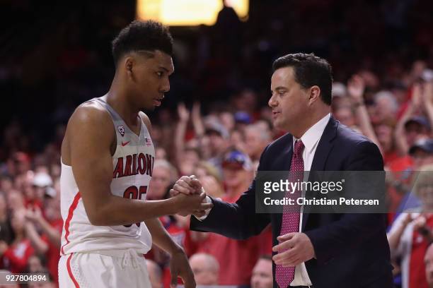 Head coach Sean Miller of the Arizona Wildcats greets Allonzo Trier after Trier checked out of the second half of the college basketball game against...