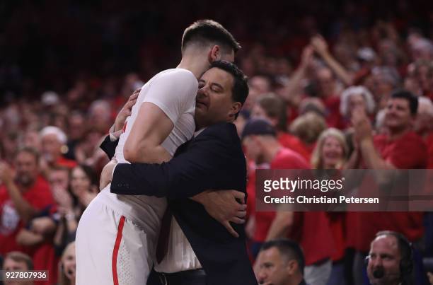 Head coach Sean Miller of the Arizona Wildcats greets Dusan Ristic after Ristic checked out of the second half of the college basketball game against...