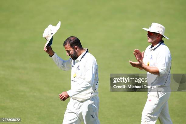 Victorious Fawad Ahmed of Victoria celebrates with Aaron Finch after taking a five wicket haul during day five of the Sheffield Shield match between...