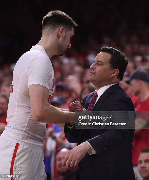 Head coach Sean Miller of the Arizona Wildcats greets Dusan Ristic after Ristic checked out of the second half of the college basketball game against...