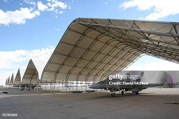 Hornet fighter jets belonging to the Canadian 410 'Couger' Squadron are seen under shelters on the tarmac at Naval Air Facility El Centro on November...