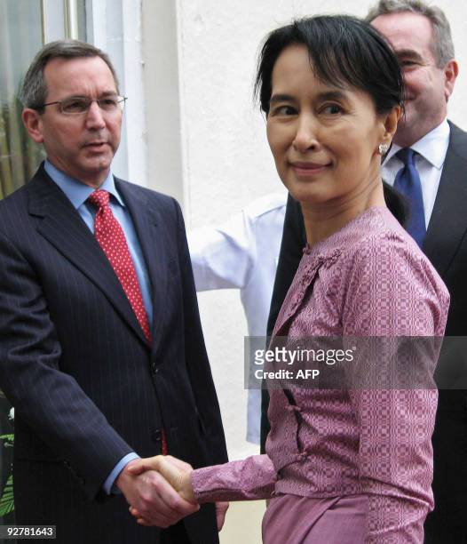 Myanmar democracy icon Aung San Suu Kyi shakes hands with deputy Scot Marciel as US Assistant Secretary of State for East Asian and Pacific Affairs...