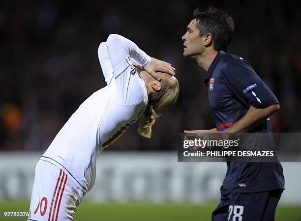 Liverpool's Ukranian forward Andriy Voronin reacts after losing a goal next to Lyon's French midfielder Jeremy Toulalan during the UEFA Champions...