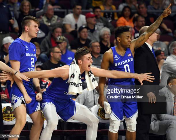 Zac Seljaas, Luke Worthington and Jahshire Hardnett react on the bench after teammate Dalton Nixon dunked against the Saint Mary's Gaels during a...