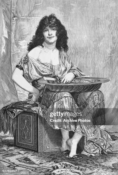 An engraving of the biblical figure of Salome, daughter of Princess Herodias. From an 1870 painting by French artist Henri Regnault. She is holding a...