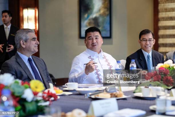 Dennis Uy, chairman and president of Phoenix Petroleum Holdings Inc., center, speaks as Jaime Augusto Zobel de Ayala, chairman and chief executive...