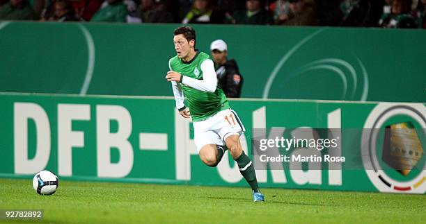 Mesut Oezil of Bremen runs with the ball during the DFB Cup round of 16 match between between Werder Bremen and 1. FC Kaiserslautern at the Weser...