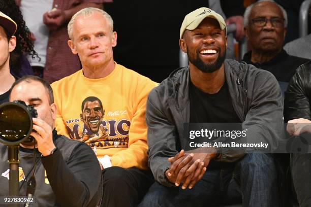 Musician Flea and actor Trevante Rhodes attend a basketball game between the Los Angeles Lakers and Portland Trail Blazers at Staples Center on March...