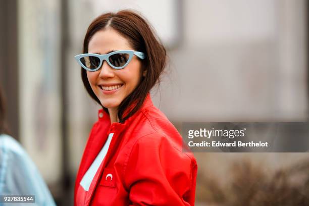 Araya Hargate wears a red jacket, a red dress, sunglasses, outside Giambattista Valli, during Paris Fashion Week Womenswear Fall/Winter 2018/2019, on...