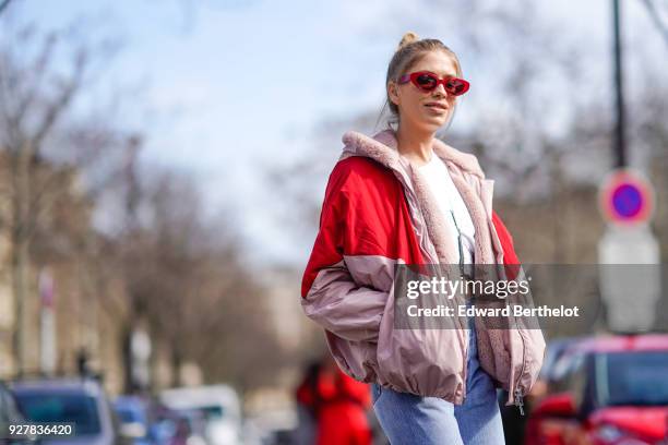 Lena Perminova wears a red and pink bomber jacket, cropped jeans, white shoes, sunglasses, outside Giambattista Valli, during Paris Fashion Week...