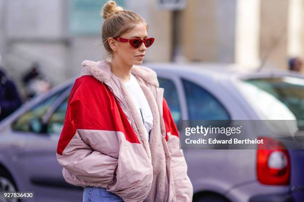 Lena Perminova wears a red and pink bomber jacket, cropped jeans, white shoes, sunglasses, outside Giambattista Valli, during Paris Fashion Week...