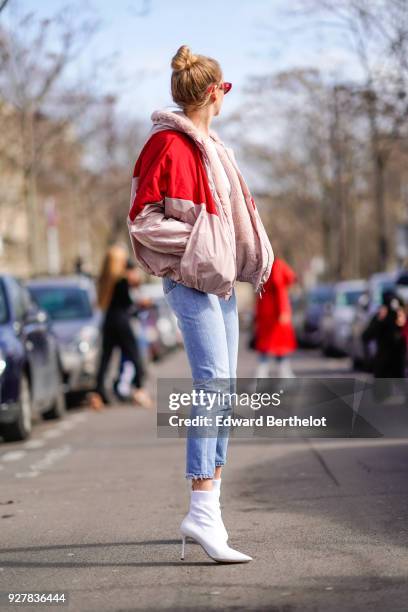 Lena Perminova wears a red and pink bomber jacket, cropped jeans, white shoes, sunglasses, outside Giambattista Valli, during Paris Fashion Week...