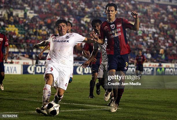 Daniel Arreola of Atlante vies for the ball with Hector Mancilla of Toluca during their match for the 2009 Opening tournament, the closing stage of...