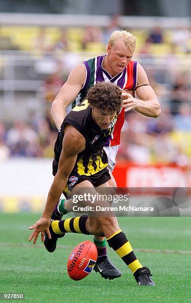 Darren Gaspar for the Tigers, attempts to keep his Freemantle opponant from the ball, during the round three Ansett Cup match between the Richmond...