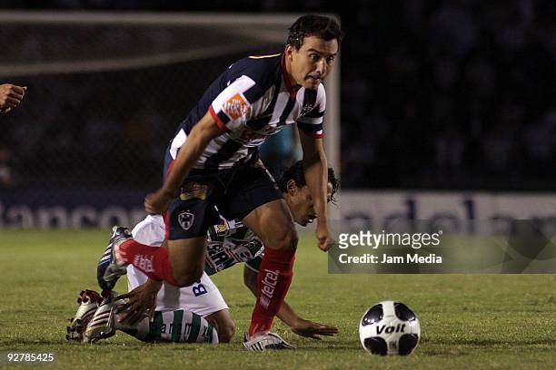 Luis Ernesto Perez of Monterrey vies for the ball with Fernando Arce of Santos during their match in the 2009 Opening tournament, the closing stage...