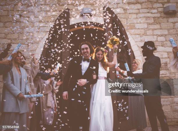 happy newlywed couple leaving church and celebrating with guests - leaving church stock pictures, royalty-free photos & images