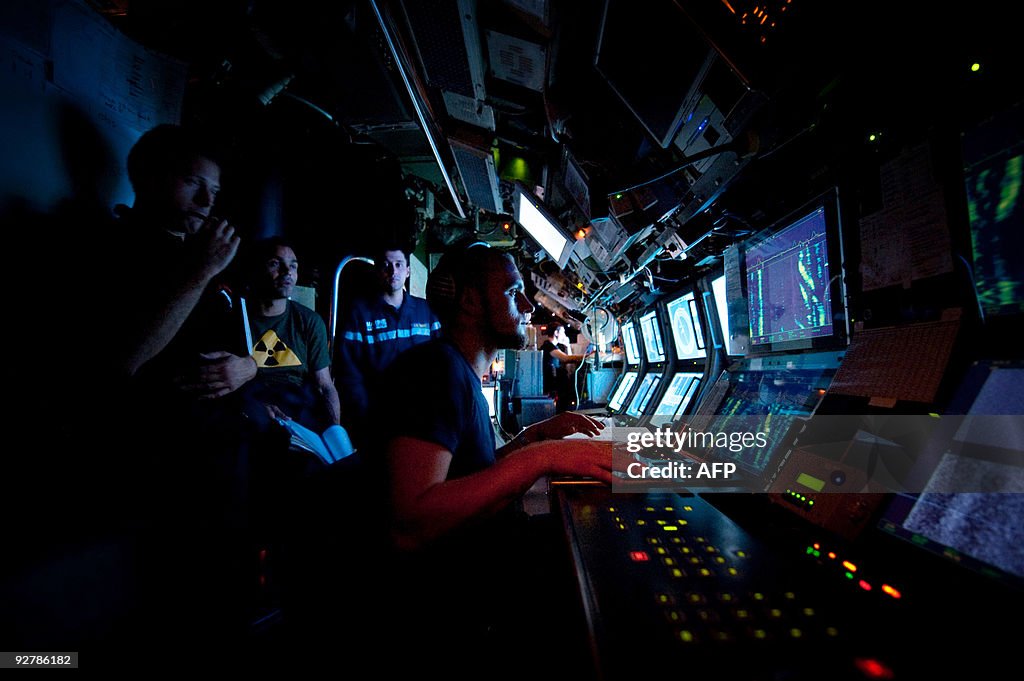 A submariner listens to a sonar in the F