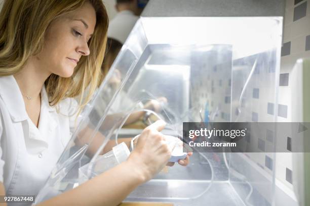 dental technician grinding dental prosthesis - crown molding imagens e fotografias de stock